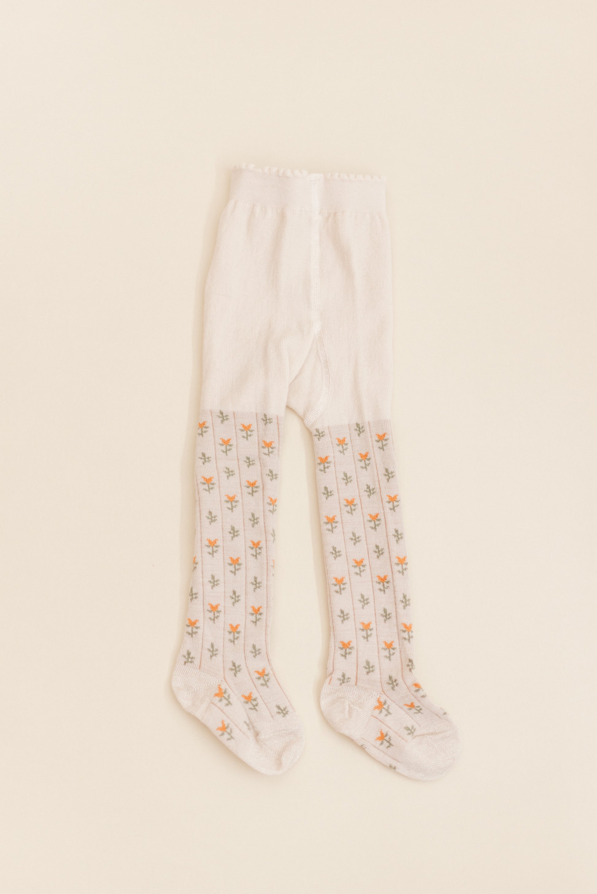 Kennedy Spice Tight from Shop Little Millers — soft oatmeal-base children’s tights with delicate spice-colored floral tulip pattern, stretch knit for a comfortable fit, designed in Arizona with OEKO-TEX® certified fabric safe for sensitive skin.