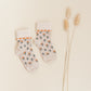 Kennedy children’s socks from Shop Little Millers, featuring a soft cream knit base with delicate floral detailing and subtle heart-inspired trim, designed for babies and kids with a snug yet stretchy fit for all-day comfort, everyday wear, and special outfits.