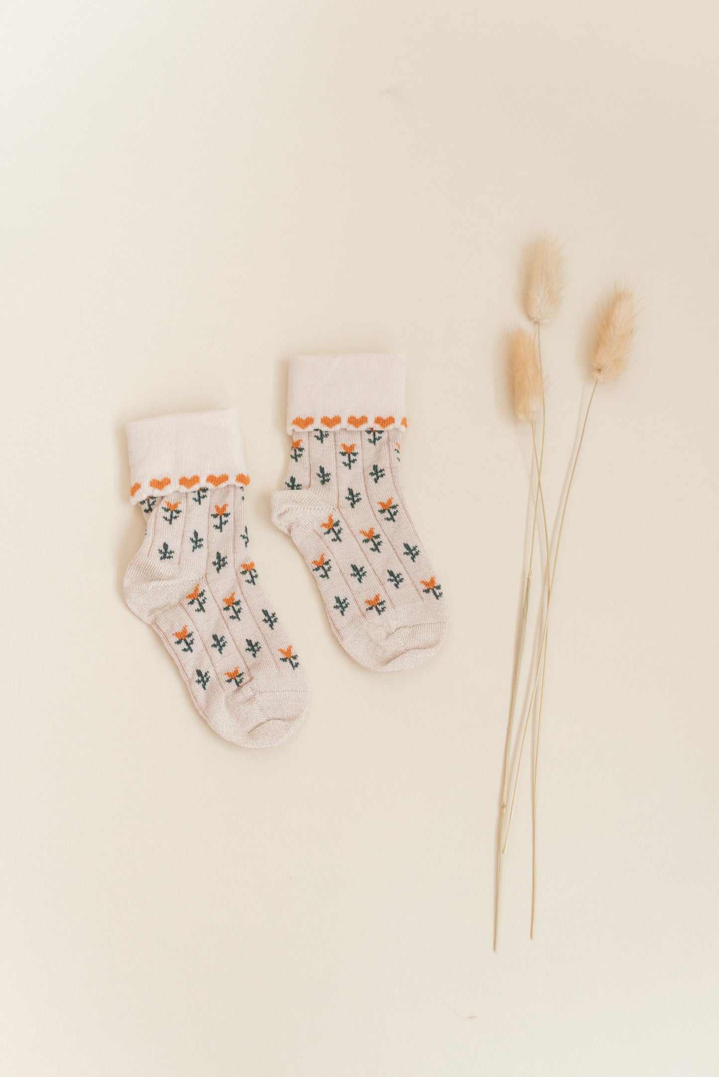Kennedy children’s socks from Shop Little Millers, featuring a soft cream knit base with delicate floral detailing and subtle heart-inspired trim, designed for babies and kids with a snug yet stretchy fit for all-day comfort, everyday wear, and special outfits.