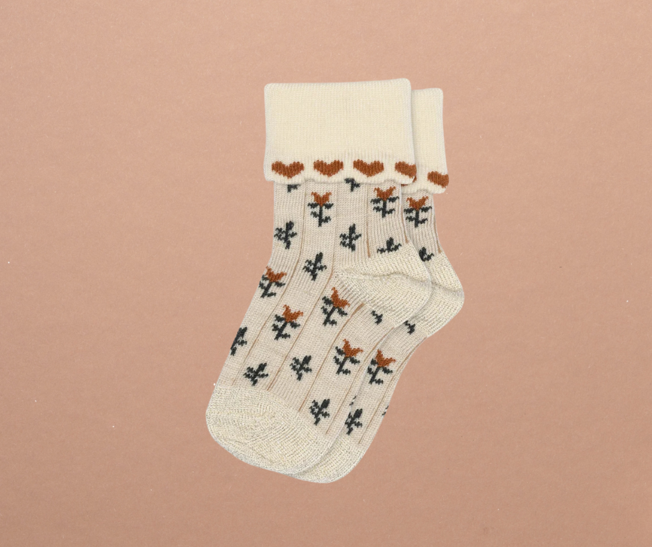 Kennedy children’s socks from Shop Little Millers, featuring a soft cream knit base with delicate floral detailing and subtle heart-inspired trim, designed for babies and kids with a snug yet stretchy fit for all-day comfort, everyday wear, and special outfits. Colors available are Mulberry, Spice or Dusty Pink.