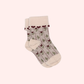 Kennedy children’s socks from Shop Little Millers, featuring a soft cream knit base with delicate floral detailing and subtle heart-inspired trim, designed for babies and kids with a snug yet stretchy fit for all-day comfort, everyday wear, and special outfits. Colors available are Mulberry, Spice or Dusty Pink.