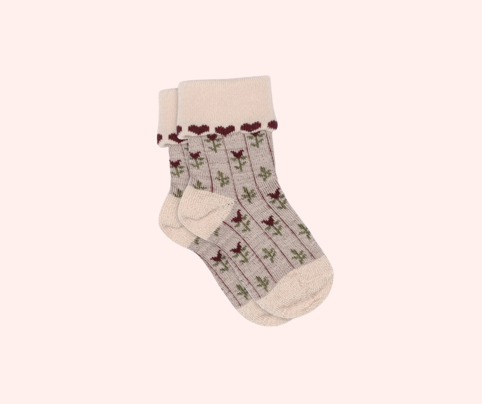 Kennedy children’s socks from Shop Little Millers, featuring a soft cream knit base with delicate floral detailing and subtle heart-inspired trim, designed for babies and kids with a snug yet stretchy fit for all-day comfort, everyday wear, and special outfits. Colors available are Mulberry, Spice or Dusty Pink.